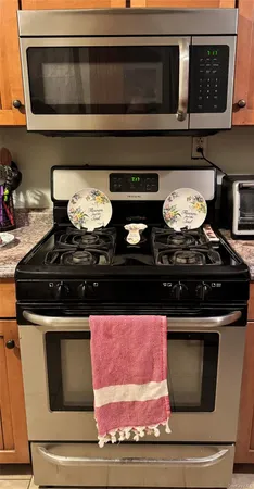 a stove top oven sitting inside of a kitchen