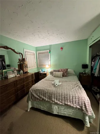 a bedroom with a bed and a dresser in it