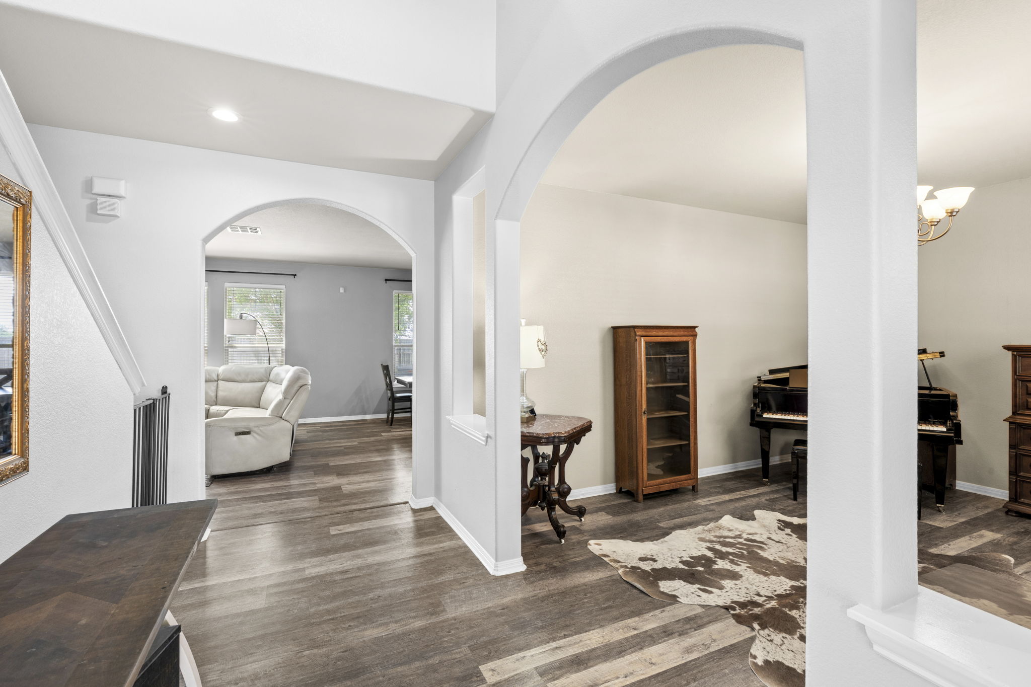 227 Sandstone Trail Buda, TX 78610 - Photo 3 of 33 Interior featuring wood-finish flooring, arched doorways, light neutral wall colors, and recessed lighting