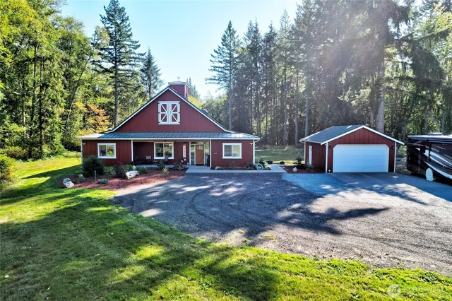 a front view of a house with yard and green space