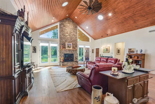 a living room with furniture a flat screen tv and a large window