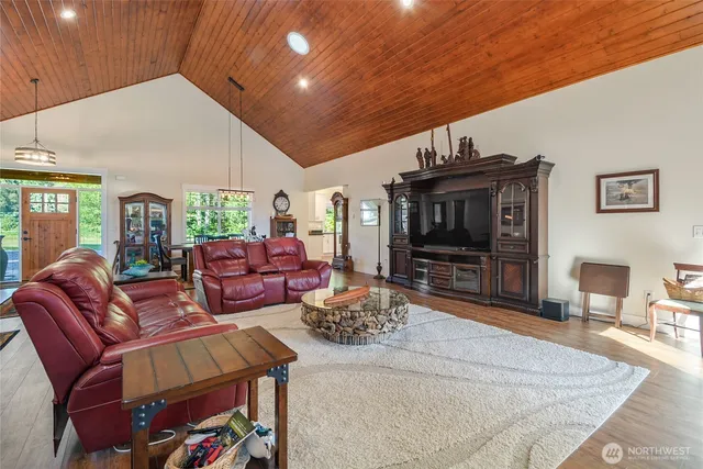 a living room with furniture a flat screen tv and a rug
