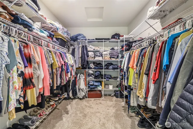a view of walk in closet with clothes