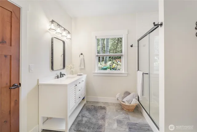 a bathroom with a double vanity sink and mirror