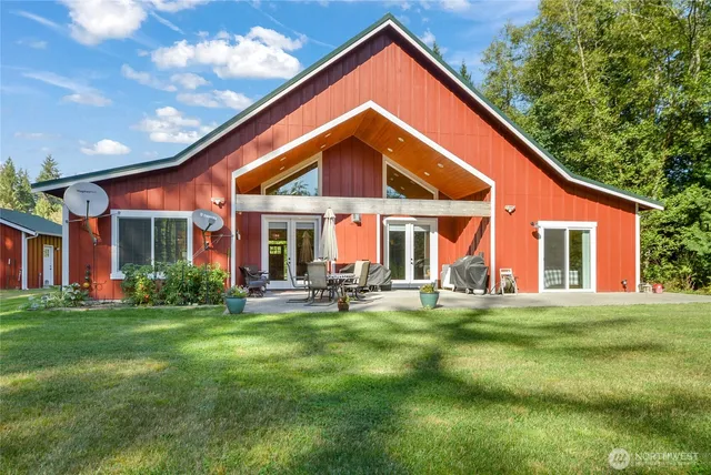 a view of a house with a yard and sitting area
