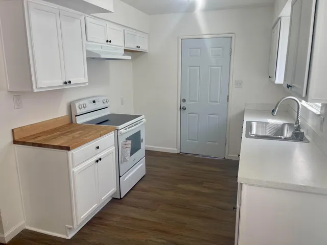 a view of a kitchen with sink and cabinets
