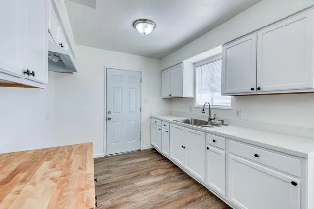 a kitchen with a sink cabinets and window