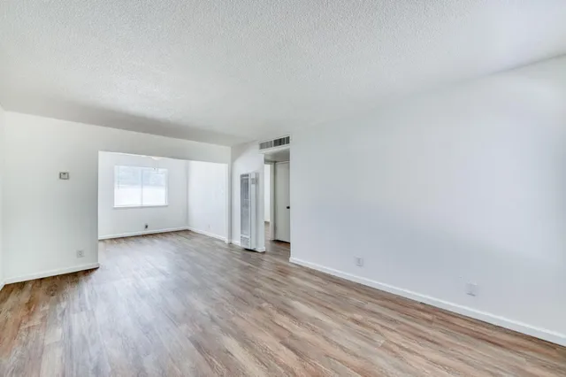 a view of an empty room and wooden floor