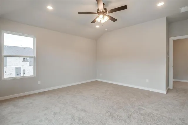 an empty room with chandelier fan