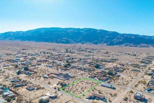 an aerial view of residential house and sandy dunes