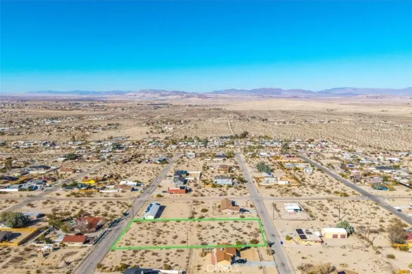 an aerial view of residential house and sandy dunes