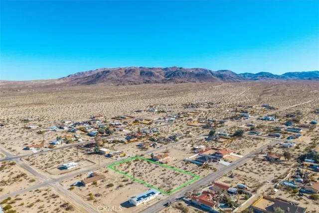an aerial view of residential house and sandy dunes