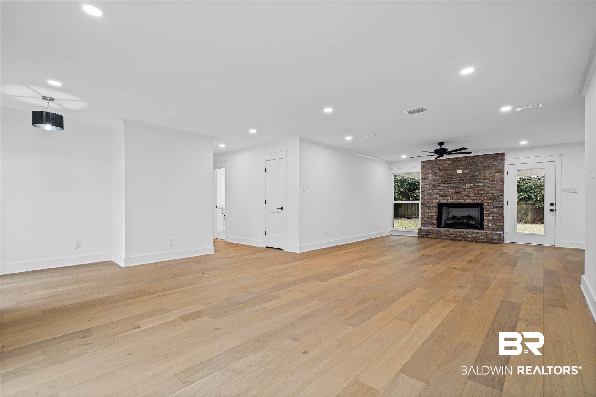 11 Schwaemmle Drive Mobile, AL 36608 - Photo 3 of 32 Unfurnished living room featuring recessed lighting, a brick fireplace, light wood-type flooring, and a ceiling fan