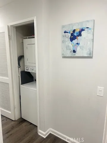 a view of a hallway with wooden floor and closet