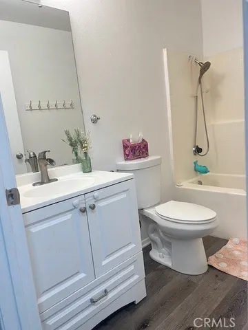 a bathroom with a toilet sink and vanity