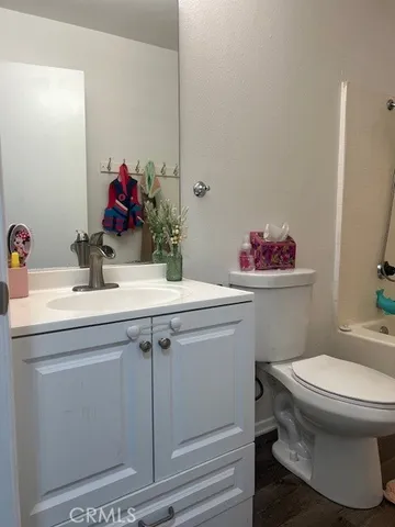 a bathroom with a sink toilet and a mirror