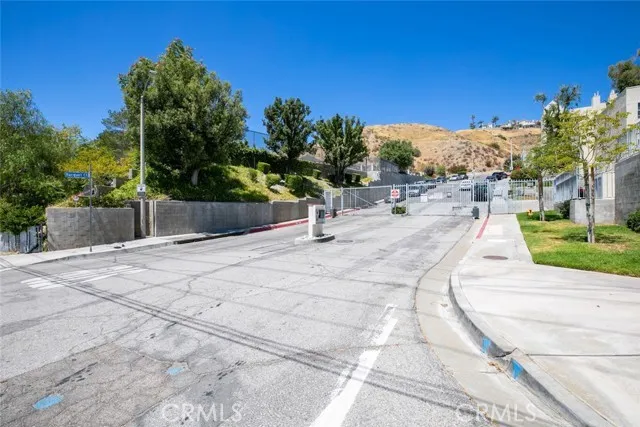 a park view with a bench in front of house