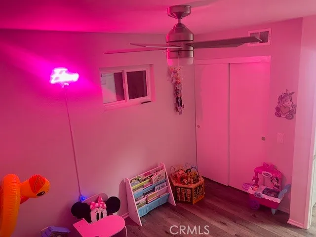 a room with a teddy bear wearing a bed