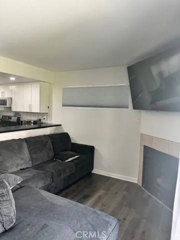 a living room with furniture and kitchen view