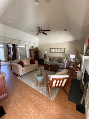 a living room with furniture and a ceiling fan