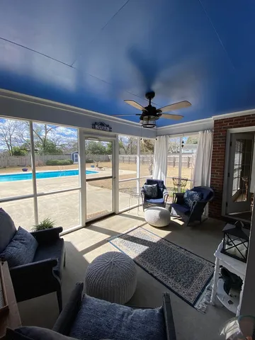 a bedroom with furniture and a large window