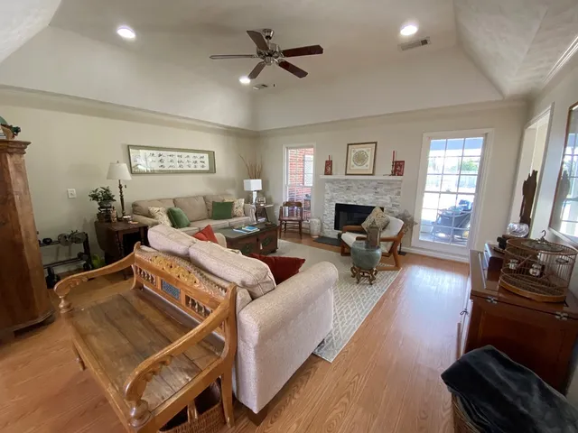 a living room with furniture fireplace and a window