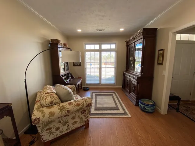 a living room with furniture gym equipment and a large window