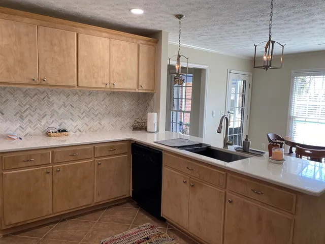 a kitchen with a sink and cabinets