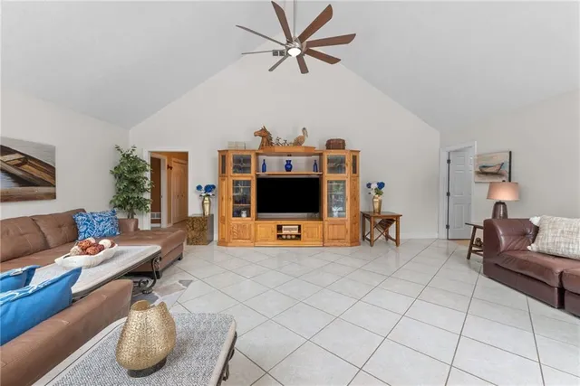 a living room with furniture a fireplace and a large window