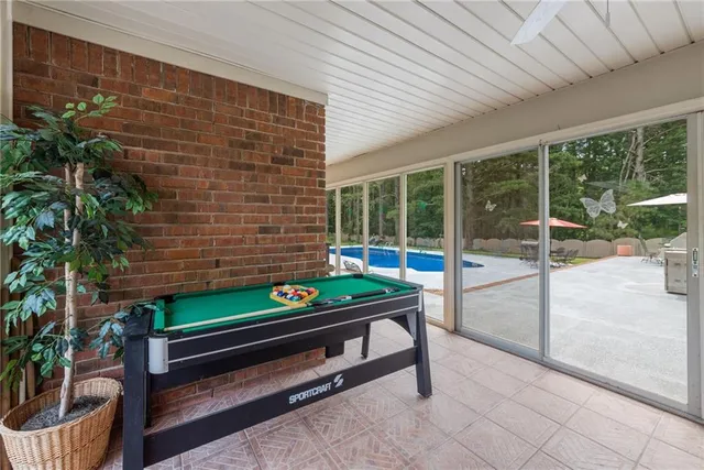 an aerial view of residential houses with outdoor space and trees