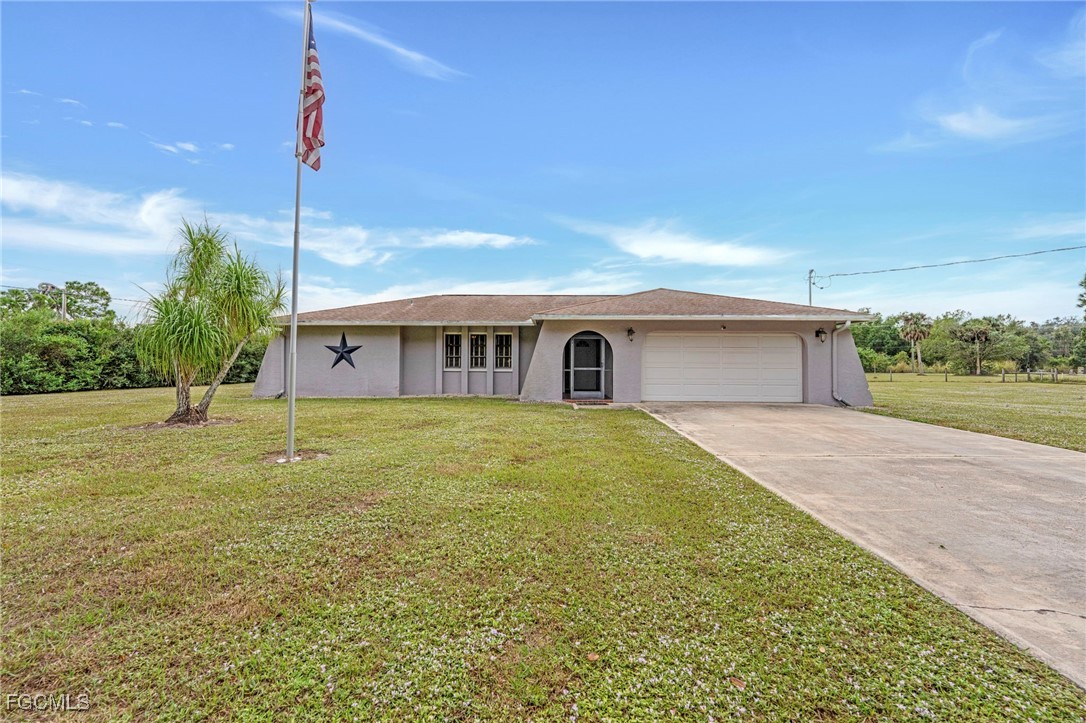a front view of house with yard and green space