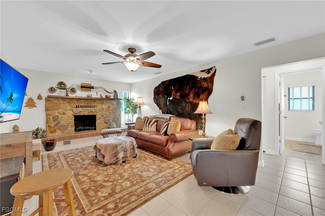 14501 Old Olga Road Fort Myers, FL 33905 - Photo 13 of 42 a living room with furniture a fireplace and a flat screen tv