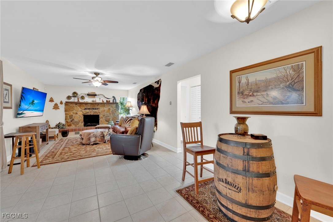 14501 Old Olga Road Fort Myers, FL 33905 - Photo 16 of 42 a living room with furniture a fireplace and a flat screen tv