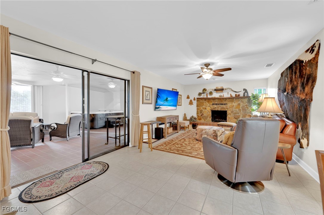 14501 Old Olga Road Fort Myers, FL 33905 - Photo 20 of 42 a living room with furniture a fireplace and a flat screen tv