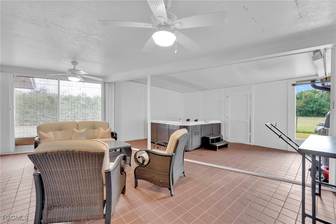 14501 Old Olga Road Fort Myers, FL 33905 - Photo 21 of 42 a living room with furniture a large window and a chandelier
