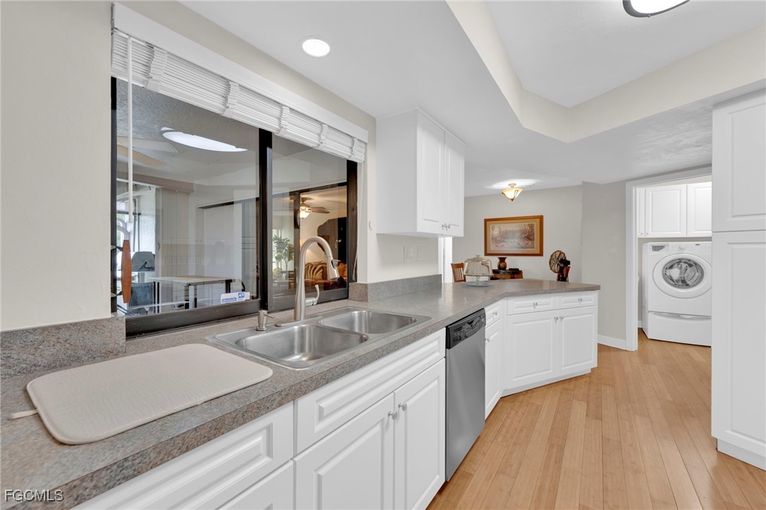 14501 Old Olga Road Fort Myers, FL 33905 - Photo 22 of 42 a large white kitchen with sink and white cabinets