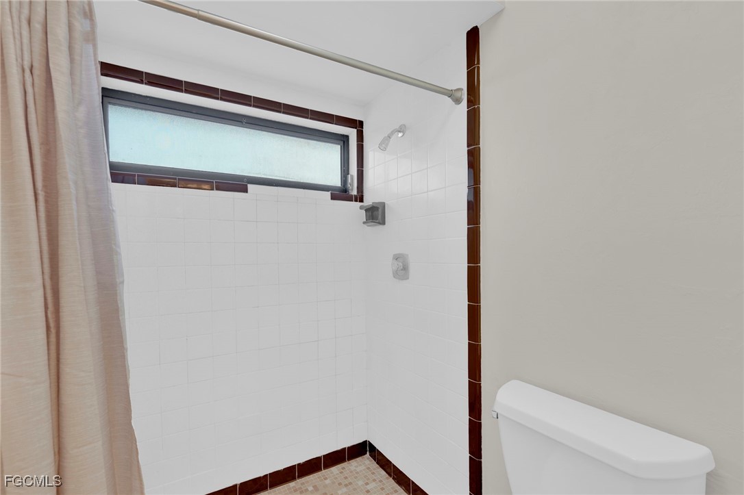 14501 Old Olga Road Fort Myers, FL 33905 - Photo 28 of 42 a bathroom with a toilet and a shower
