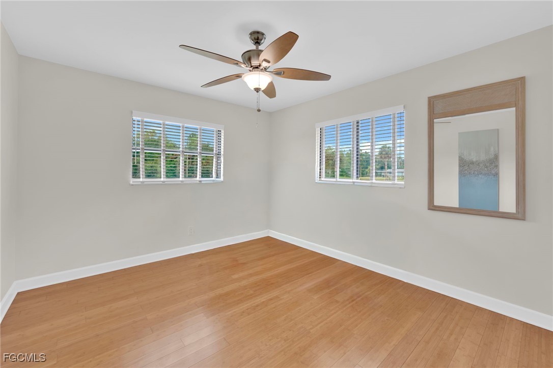 14501 Old Olga Road Fort Myers, FL 33905 - Photo 31 of 42 a view of an empty room with wooden floor and a window