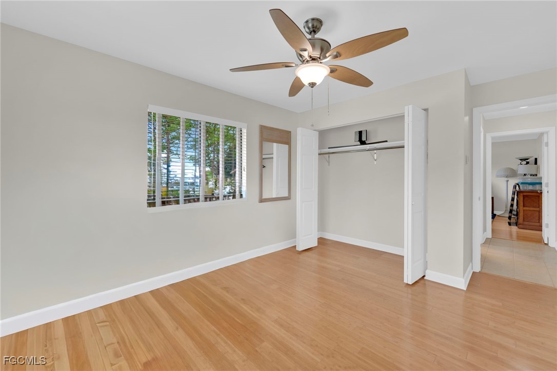 14501 Old Olga Road Fort Myers, FL 33905 - Photo 32 of 42 wooden floor in an empty room with a window