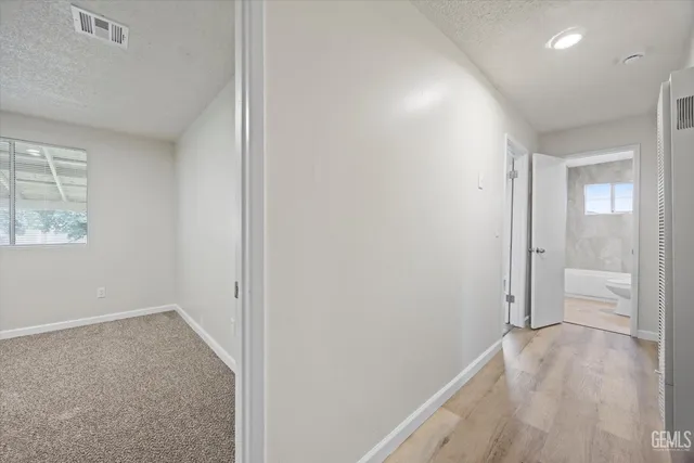 an empty room with windows and closet