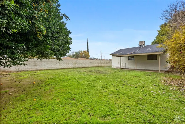 a front view of house with yard and trees