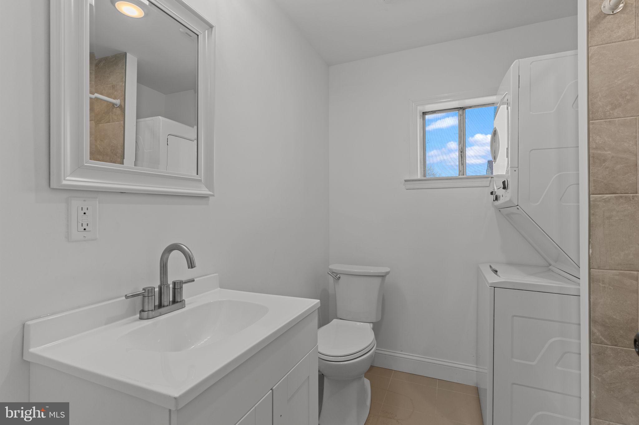 908 State Rd., Unit B Croydon, PA 19021 - Photo 7 of 9 a bathroom with a sink mirror and toilet