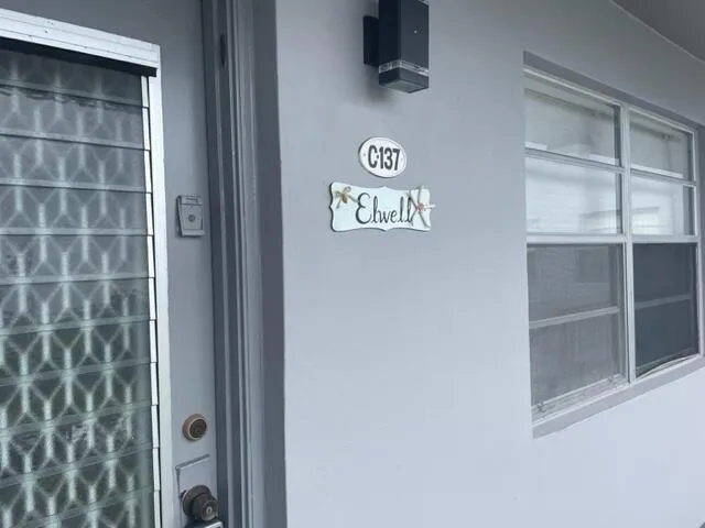 a view of a door and wooden floor