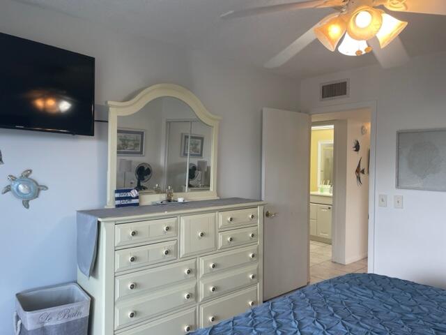 137 Flanders C Delray Beach, FL 33484 - Photo 15 of 55 a bedroom with a bed and a flat screen tv
