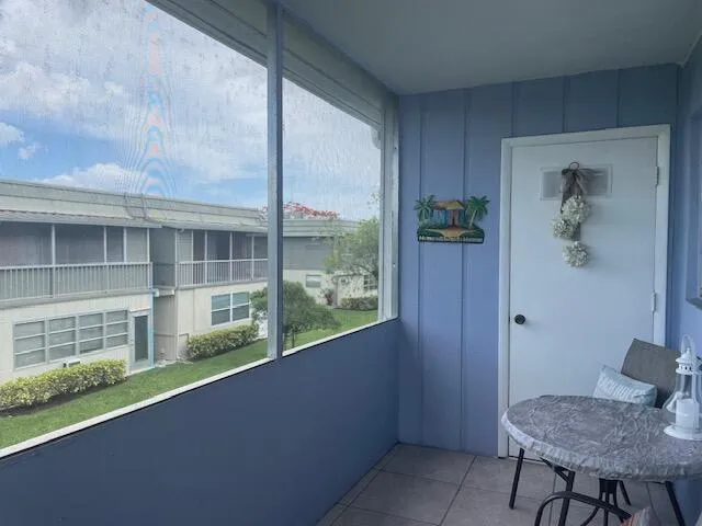 a view of a balcony and chair and table in kitchen
