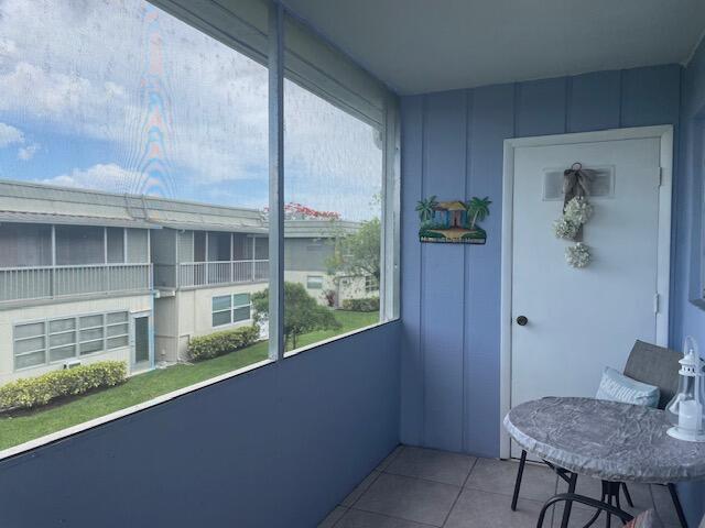 137 Flanders C Delray Beach, FL 33484 - Photo 16 of 55 a view of a balcony and chair and table in kitchen