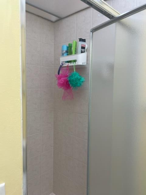 137 Flanders C Delray Beach, FL 33484 - Photo 20 of 55 a bathroom with a shower curtain