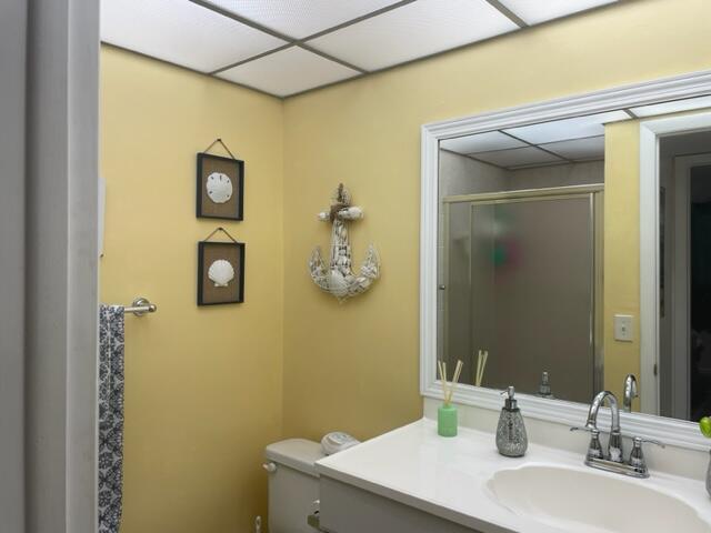 137 Flanders C Delray Beach, FL 33484 - Photo 22 of 55 a bathroom with a sink mirror and vanity