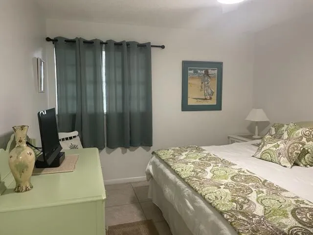 a bedroom with a bed and a dresser