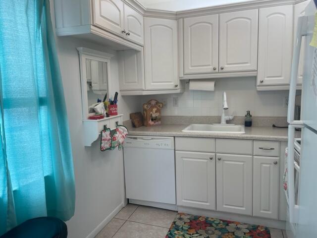 137 Flanders C Delray Beach, FL 33484 - Photo 3 of 55 a kitchen with white cabinets and sink